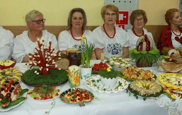 Stoły wielkanocne przygotowane przez panie z K&oacute;ł Gospodyń Wiejskich. Na stołach tradycyjne wielkanocne potrawy. 