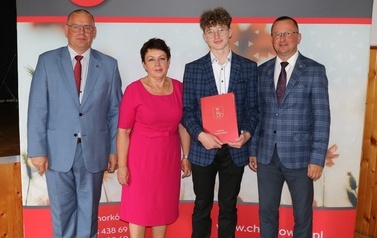 Zdjęcie ucznia z przedstawicielami gminy i dyrektorem. 