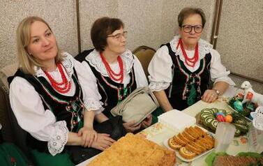 Zdjęcia ukazują bogactwo podkarpackiego folkloru. Członkinie KGW z całej gminy prezentują się w tradycyjnych strojach: białych, haftowanych bluzkach z kryzami oraz charakterystycznych czerwonych koralach. Siedzą przy stołach uginających się od tradycyjnyc