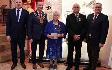 Zdjęcia z uroczystości Złotych God&oacute;w w Domu Ludowym w Zręcinie. Przedstawiają one występy męskiej sekcji Zespołu Śpiewaczego &bdquo;Chorkowianie&rdquo; w tradycyjnych strojach ludowych, oficjalne wystąpienie władz gminy Chork&oacute;wka oraz pamiątkowe kadry z jubilatami odznaczonymi Medalami za Długoletnie Pożycie Małżeńskie.