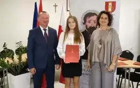 Stypendystka w towarzystw w&oacute;jta i pani dyrektor. Zdjęcie po odebraniu nagrody. 